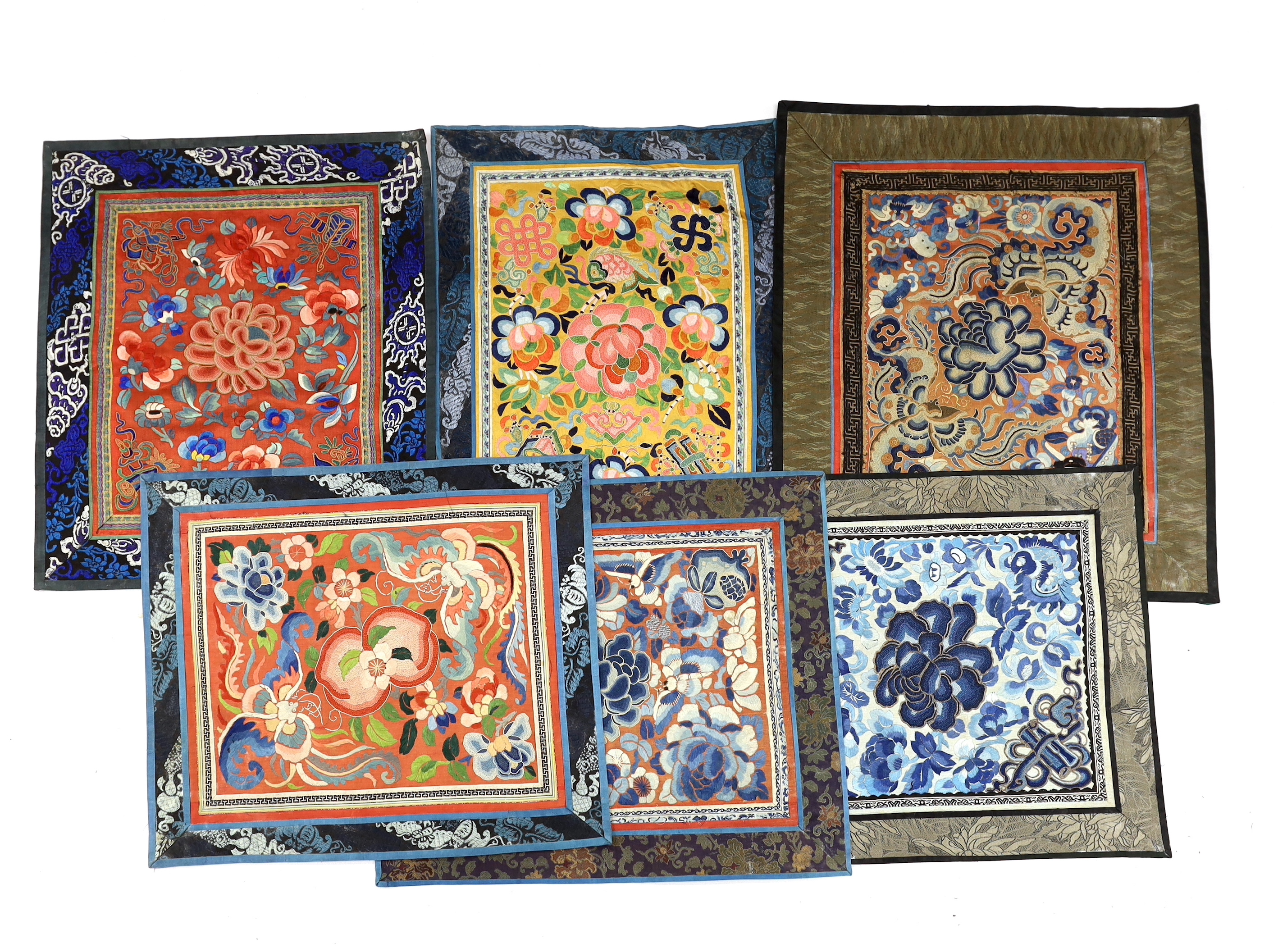 Six panels of Chinese silk embroidery, all using mixed stitches including Beijing knot, all bordered with silk brocade, largest 44cm x 38cm